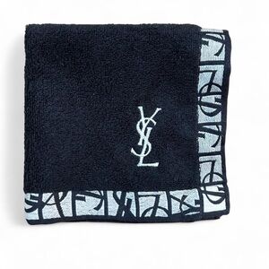 Black YSL wash cloth with white stitched logo.
